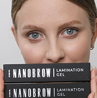 Modelka trzymająca dwa pudełka żelu do laminacji Nanobrow zakrywająca usta